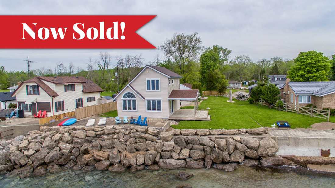 Sold banner on photo of 2 storey, sided, Lakefront home with metal roof located on Lake Erie in Wainfleet Ontario