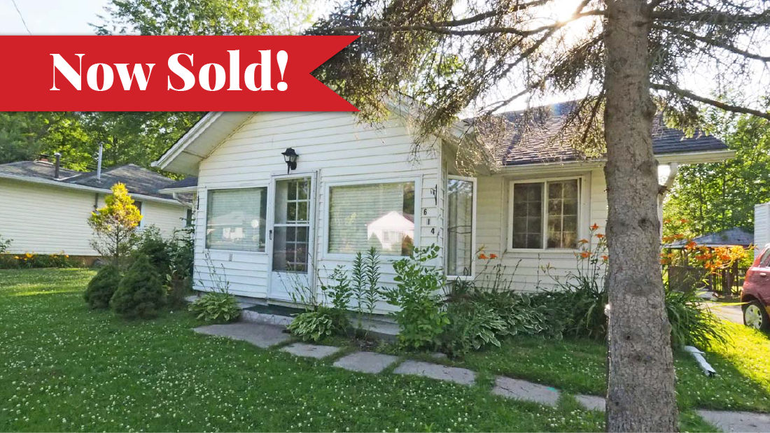 Sold banner on white sided home for sale at 614 Silver Bay Road in Port Colborne
