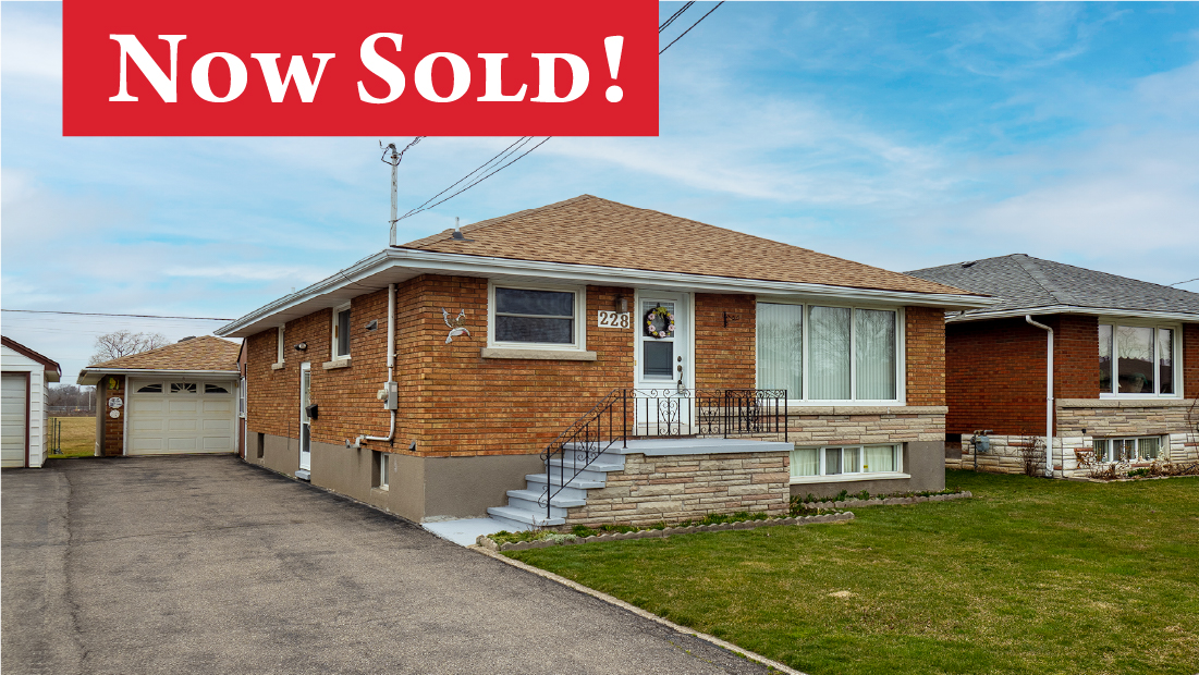 Now Sold banner on exterior photo of brick bungalow at 228 Clarke Street Port Colborne