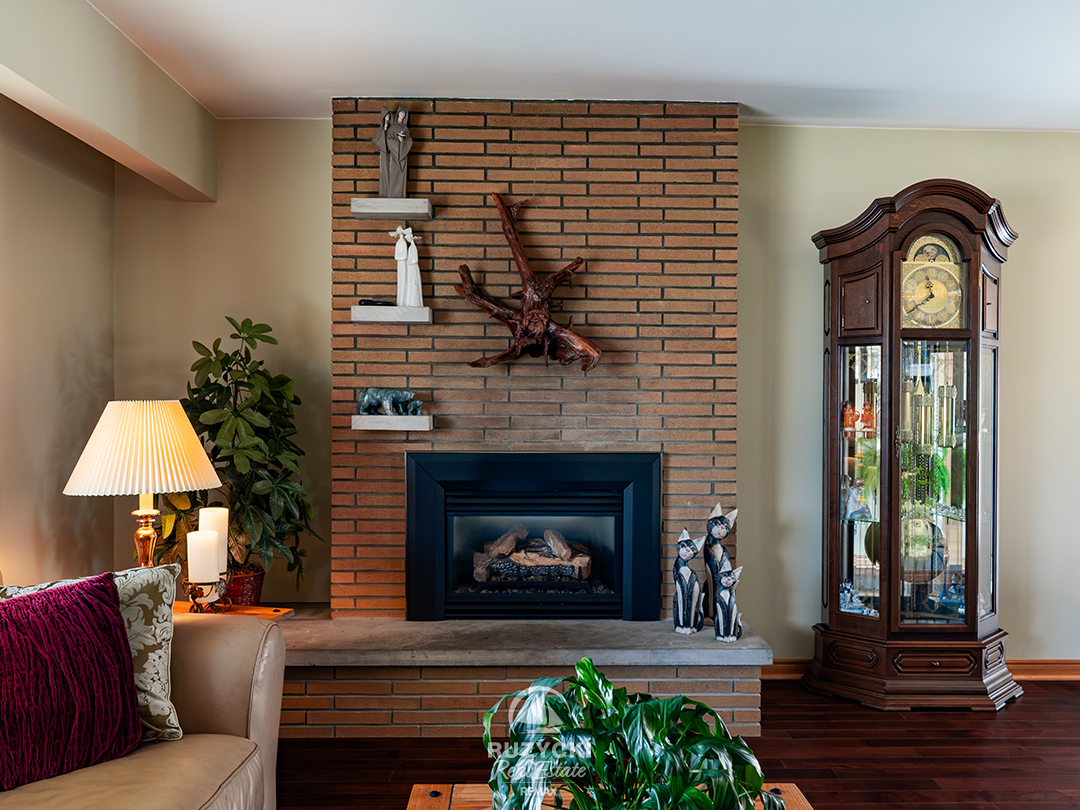 82-scholfield-ave-port-colborne_15 Brick front gas fireplace with driftwood accent in living room at 82 Scholfield Ave
