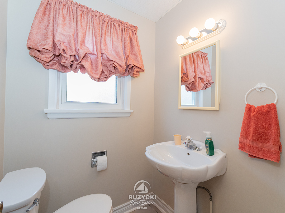 82-scholfield-ave-port-colborne_19 Powder room with pink accents on the mainfloor of 82 Scholfield Ave in Port Colborne