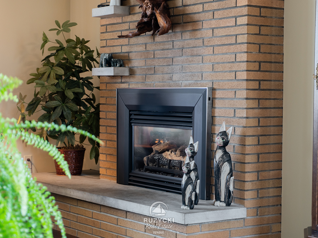 82-scholfield-ave-port-colborne_32 Close up of gas fireplace with brick front in the living room of 82 Scholfield Ave