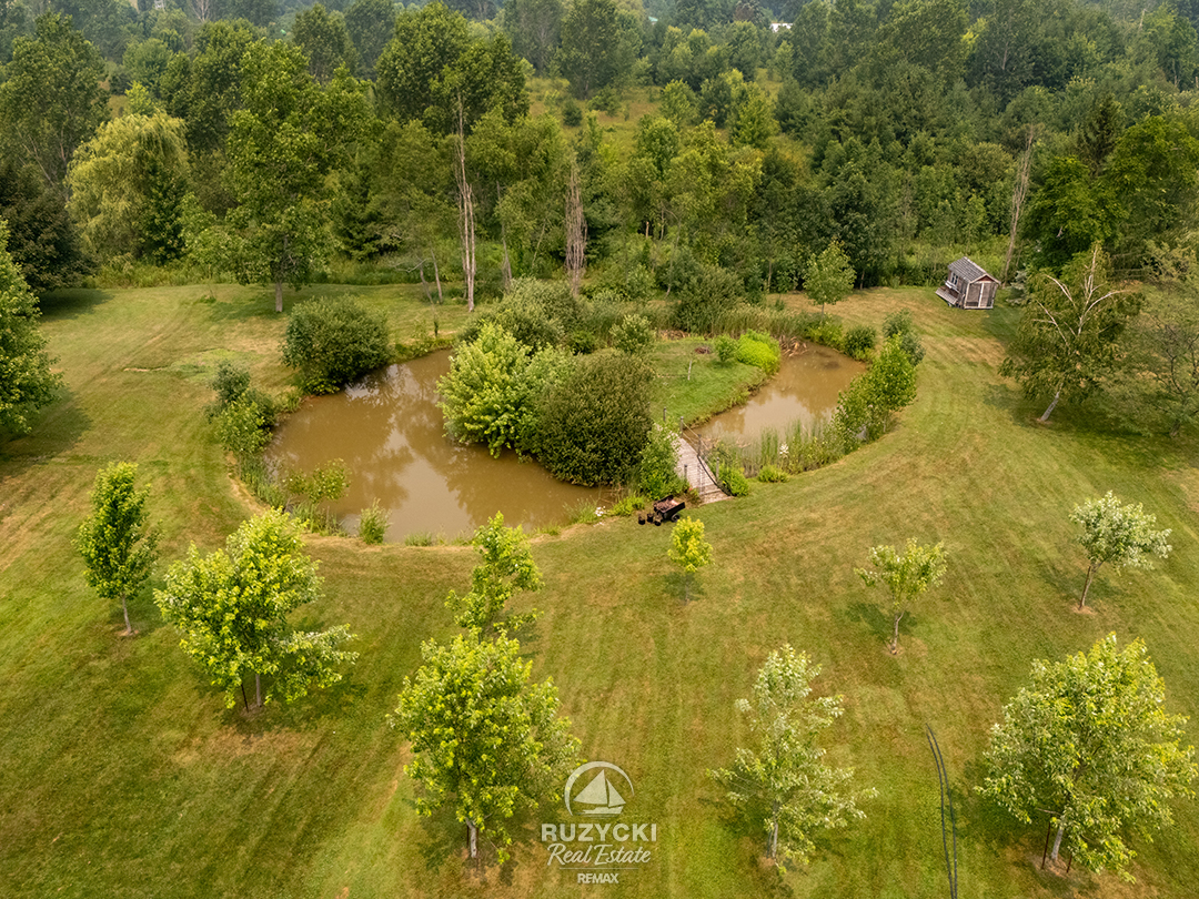 11004-lakeshore-rd-wainfleet_69 large backyard pond with small island of 11004 lakeshore rd wainfleet