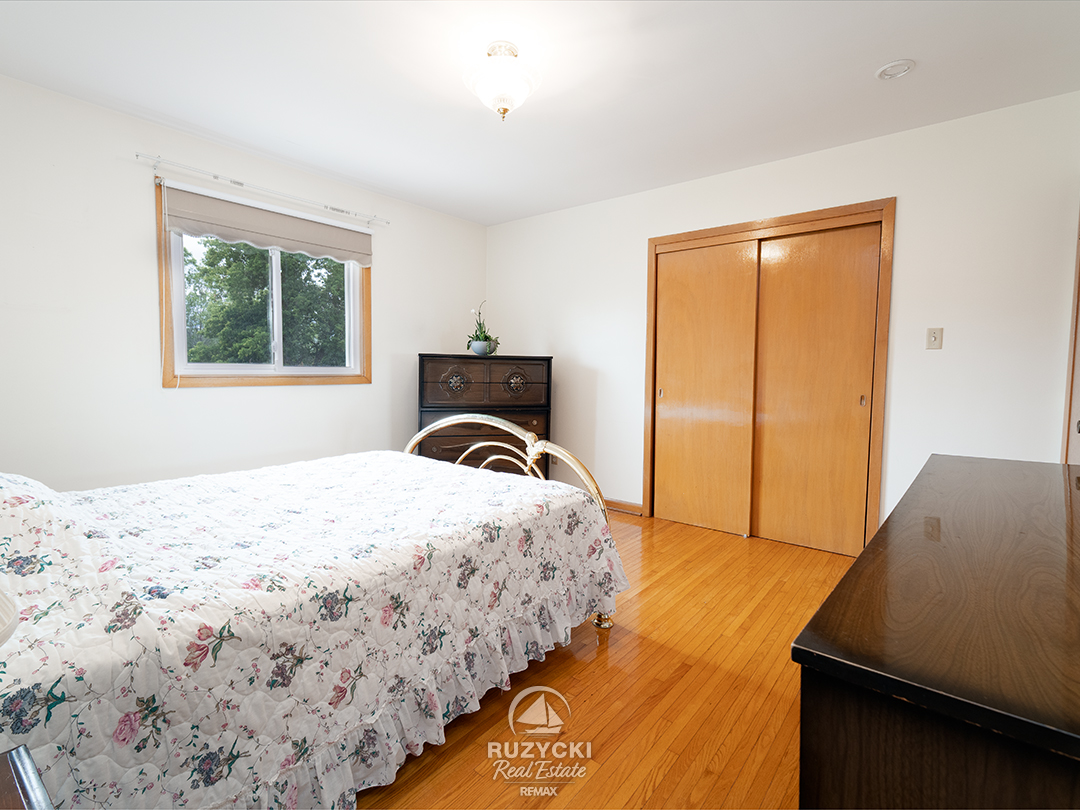 167-wellington-st-port-colborne_20 Main floor bedroom with wood floors in bungalow for sale in Port Colborne
