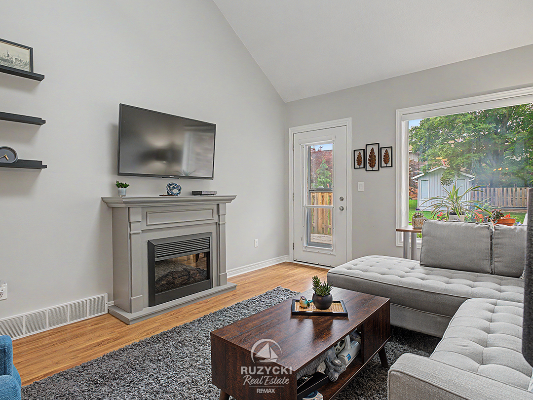 319-elgin-street-port-colborne_40 open concept living room with fireplace and access to rear patio