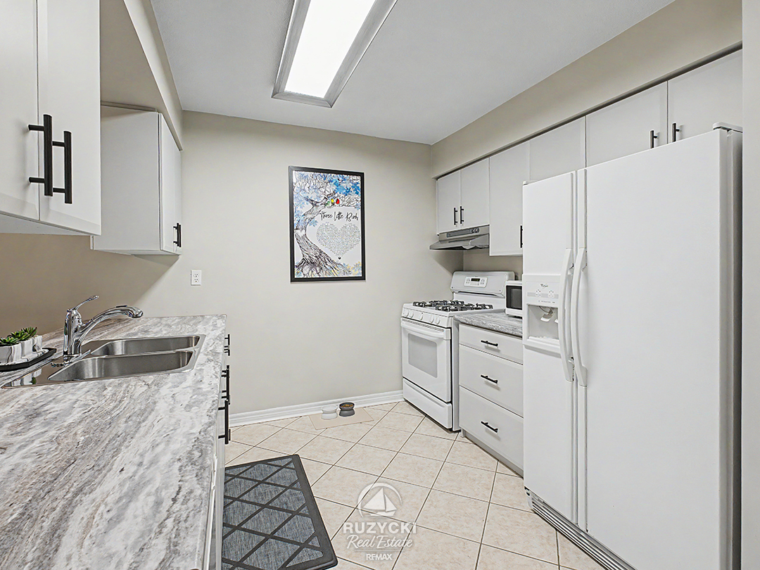 319-elgin-street-port-colborne_44 kitchen with white cabinetry and appliances