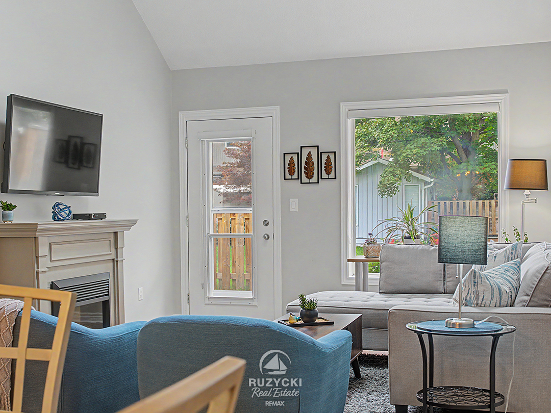 319-elgin-street-port-colborne_71 open concept living room with fireplace and access to rear patio