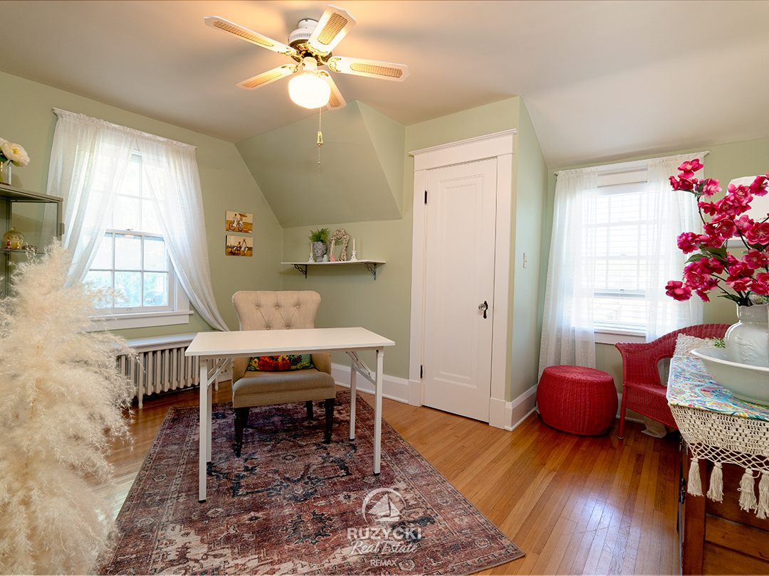344-clarence-street-port-colborne_44 bedroom/office with sage green walls and hardwood floors