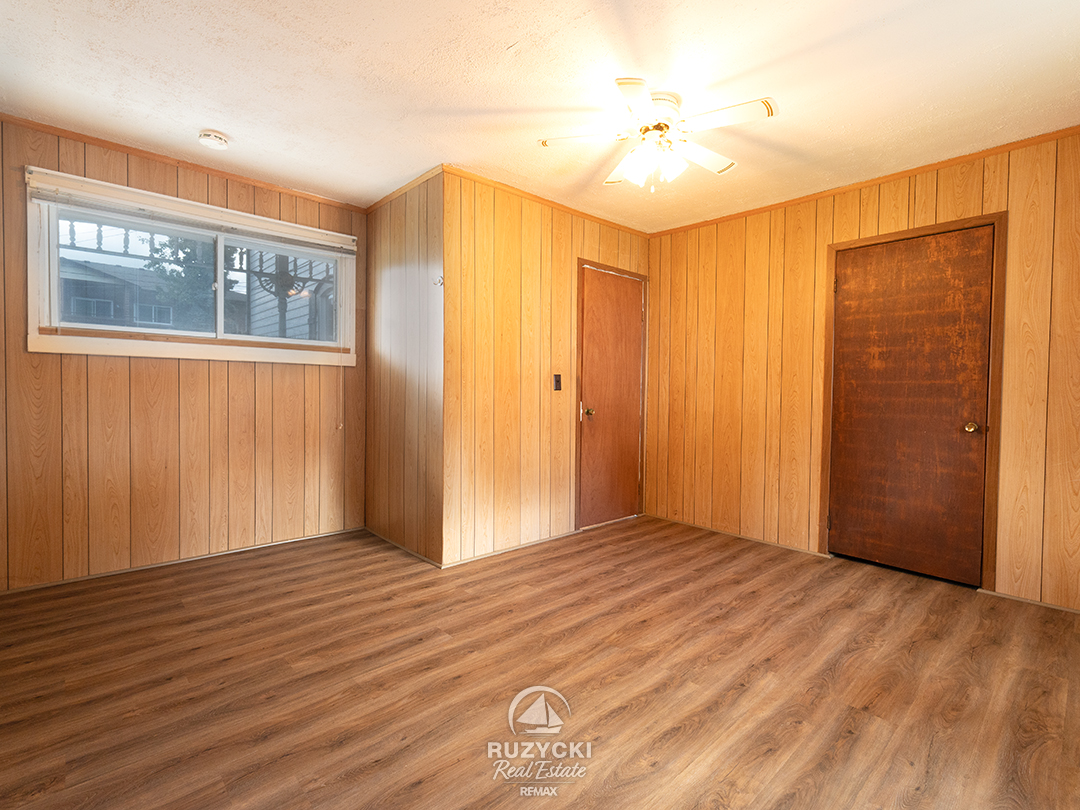 632-king-street-port-colborne_39 wood panelled bedroom in apartment unit
