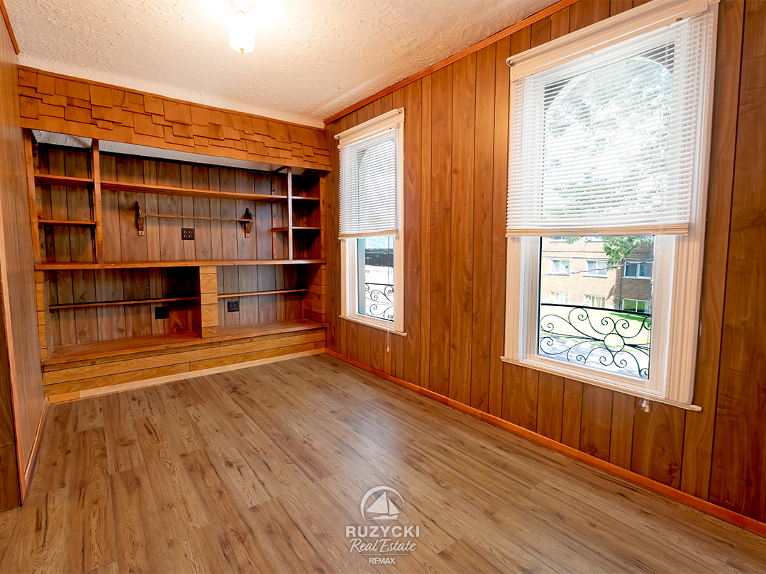 632-king-street-port-colborne_54 wood panelled bedroom with built in shelving