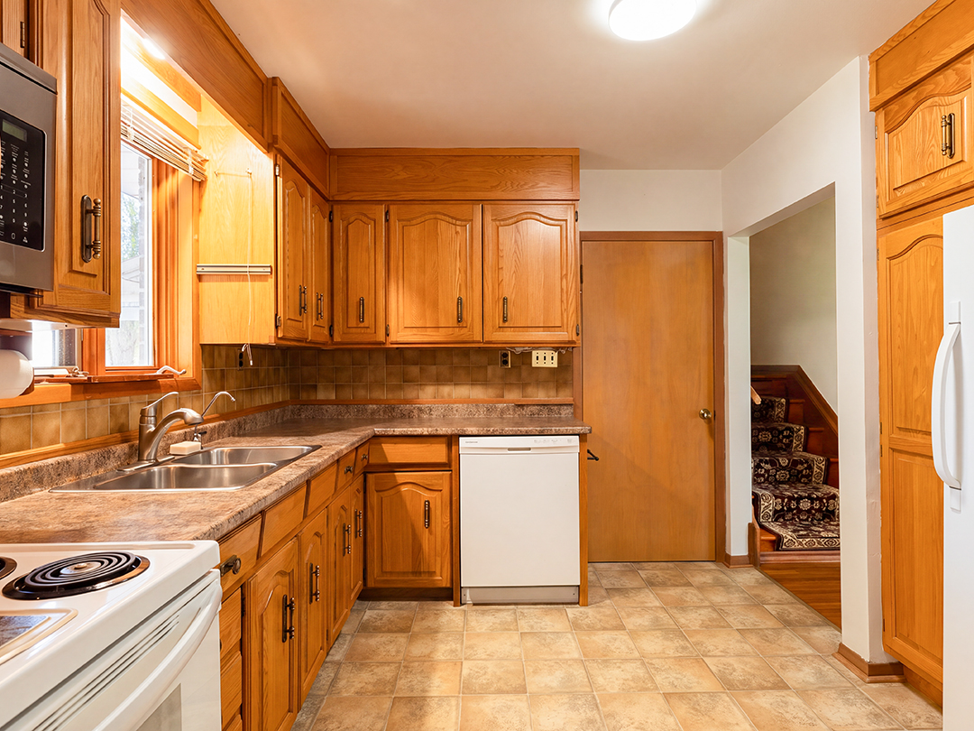 29-runnymede-road-port-colborne_15 kitchen with rich wood cabinetry