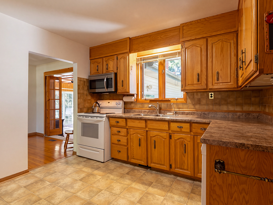 29-runnymede-road-port-colborne_16 kitchen with rich wooden cabinetry